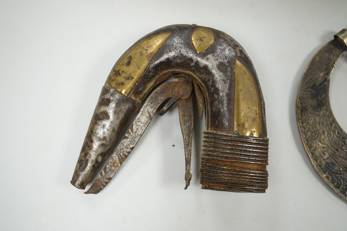A niello work belt buckle, 21cm wide, an Arab white metal cloak brooch and a powder flask
